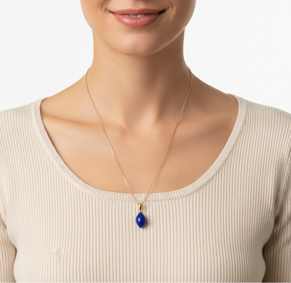Eine Frau in beigem Pullover trägt eine Halskette aus 585 Gold mit einem Edelsteinanhänger aus Lapislazuli 22mm